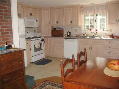 46 Pilgrim Road Harwich Port, MA 02646 - Photo 6 of 17 a kitchen with granite countertop white cabinets and white appliances