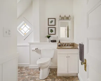 a bathroom with a sink a toilet and mirror