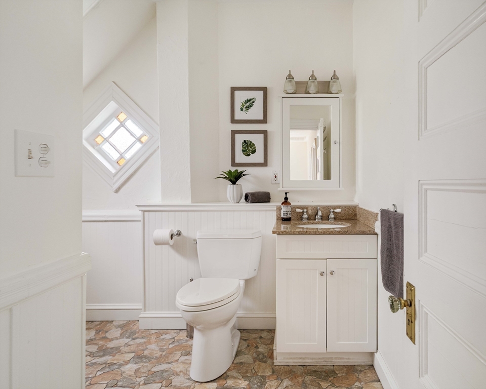 52 Walter Street Boston, MA 02131 - Photo 20 of 31 a bathroom with a sink a toilet and mirror