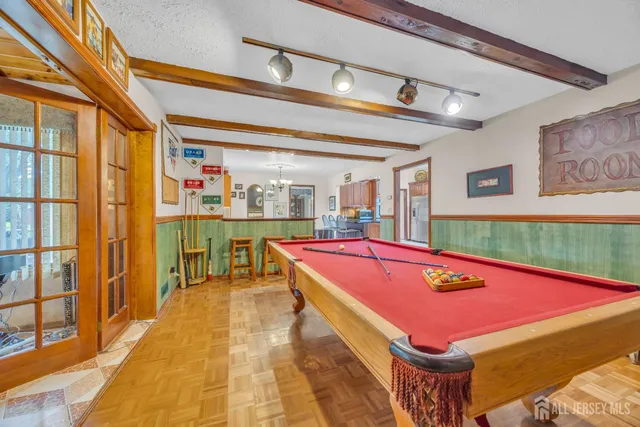 a room with pool table and large windows