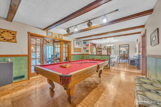 a room with pool table and windows