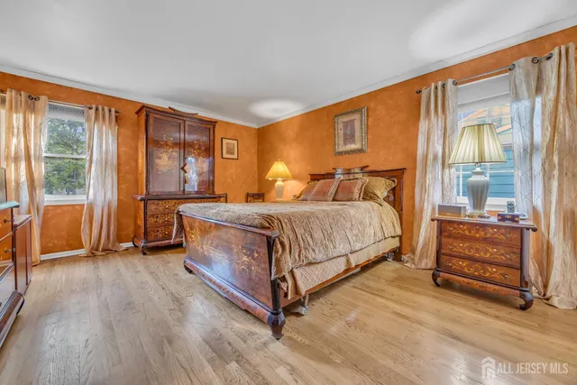 a bedroom with a bed and large window