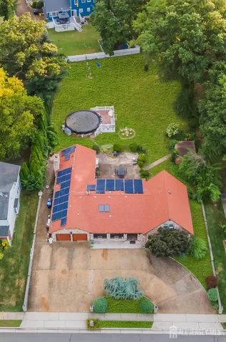 an aerial view of a house with outdoor space lake view and car parked