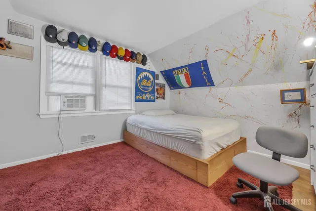 a bedroom with a bed and a chair