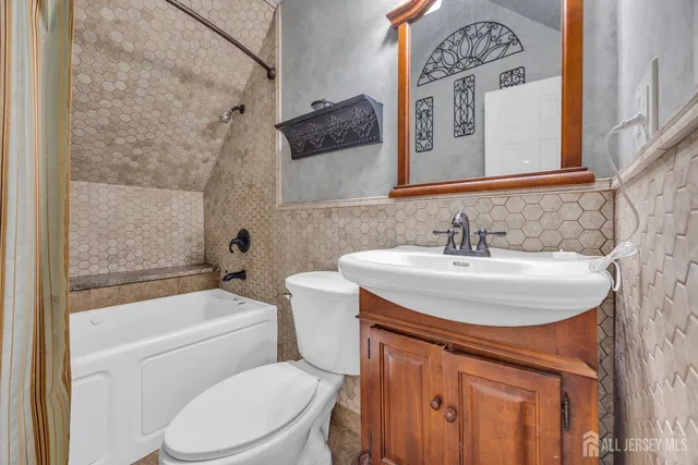 a bathroom with a toilet a sink and a bath tub