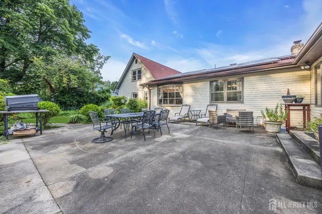 a view of a house with backyard sitting area and garden
