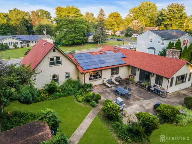 a aerial view of a house with a yard table and chairs