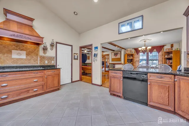 a large kitchen with stainless steel appliances granite countertop a stove and a sink