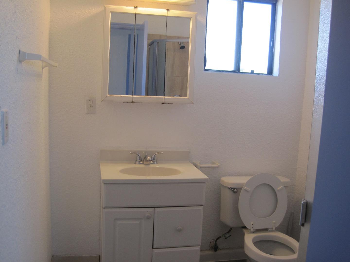 1225 Beacon Avenue San Mateo, CA 94401 - Photo 13 of 21 a bathroom with a sink toilet and mirror