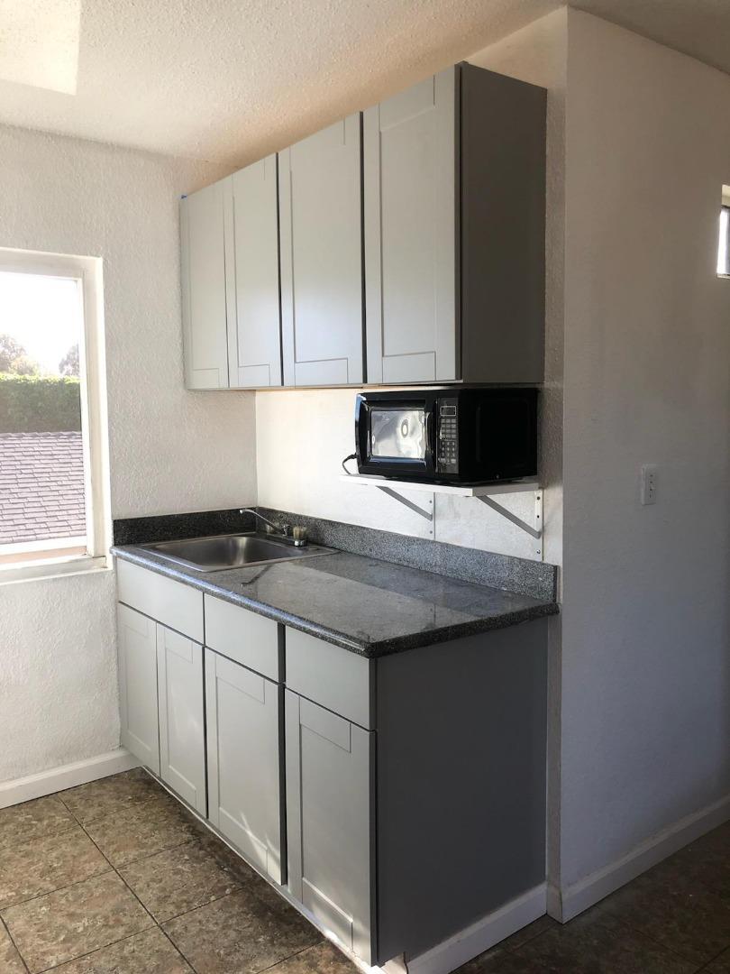1225 Beacon Avenue San Mateo, CA 94401 - Photo 3 of 21 a kitchen with granite countertop a sink and a stove