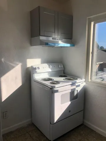 a stove top oven sitting inside of a kitchen