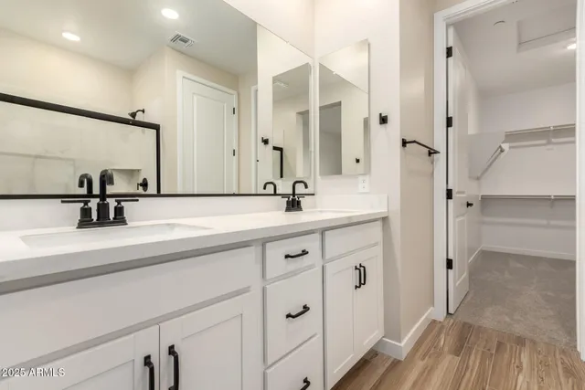 a bathroom with a glass shower door