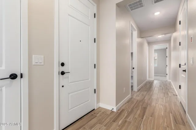 a view of a hallway with wooden floor