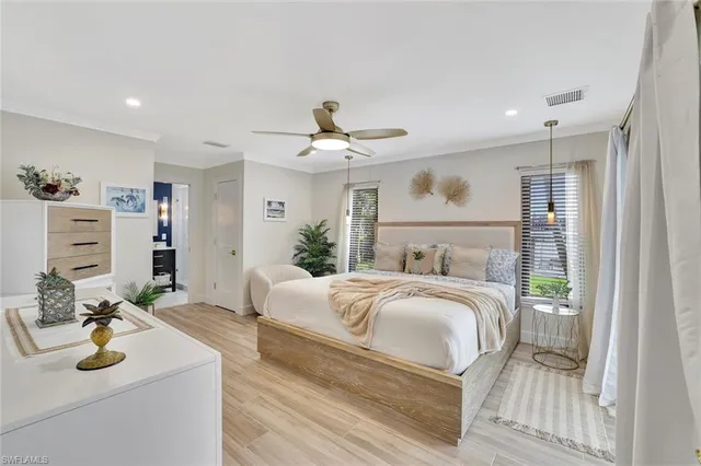 a kitchen with stainless steel appliances kitchen island granite countertop a table chairs and white cabinets