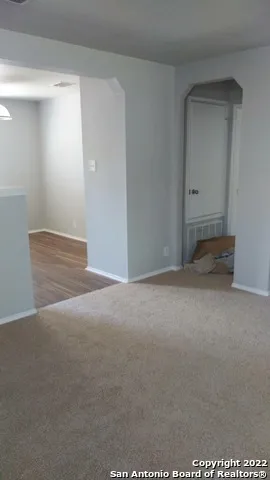 an empty room with a empty space and windows