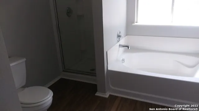 a bathroom with a bathtub and a window