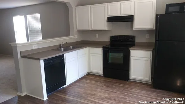 a kitchen with a sink dishwasher a refrigerator and a stove