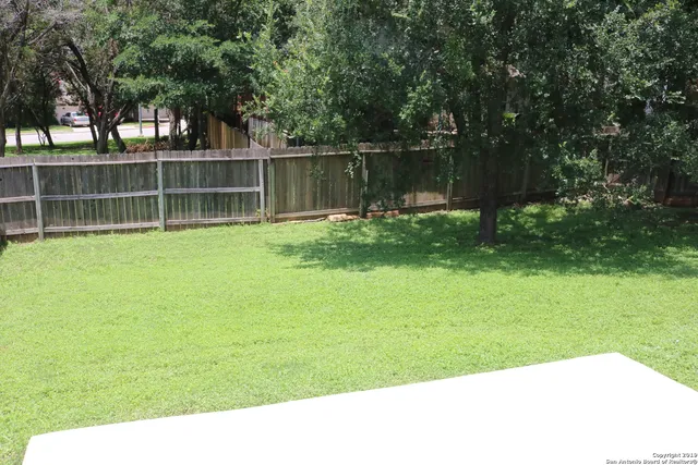 a view of outdoor space with deck and trees