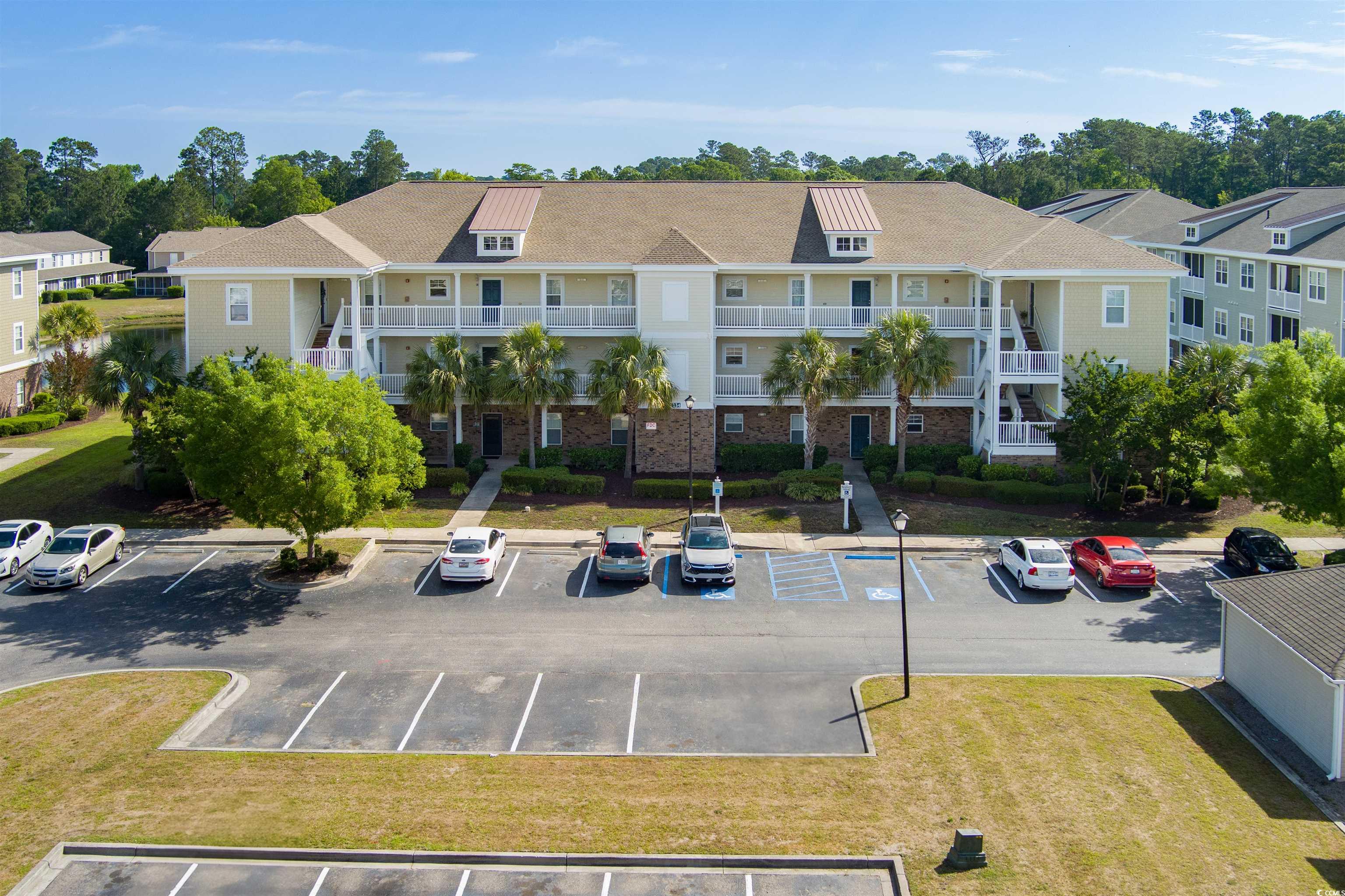 View of property with uncovered parking and a resi