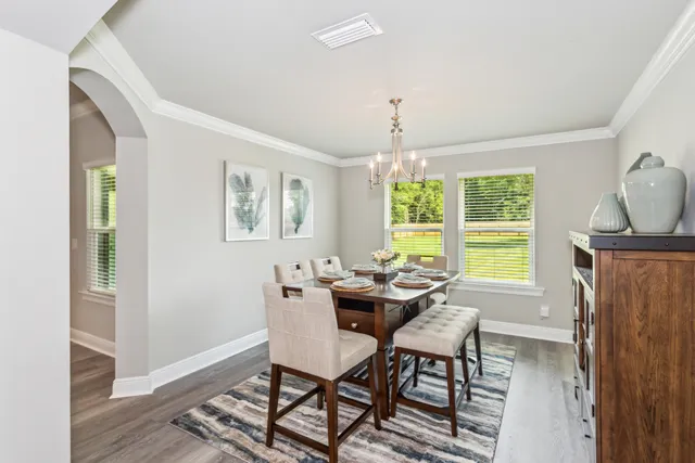 a dining room with furniture and window
