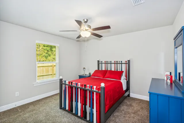 a bed room with a bed and a window