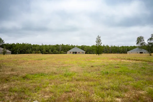 a view of a lake with houses in the back