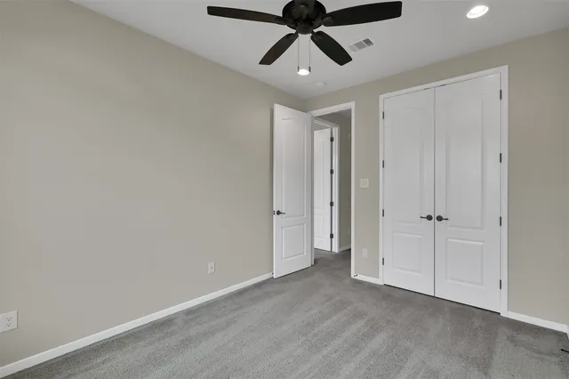 a bathroom with a double vanity sink toilet and a mirror