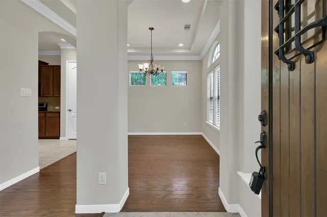 a view of a livingroom with a ceiling fan wooden floor and a ceiling fan