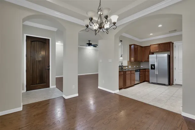 a kitchen with stainless steel appliances granite countertop a refrigerator and a stove top oven