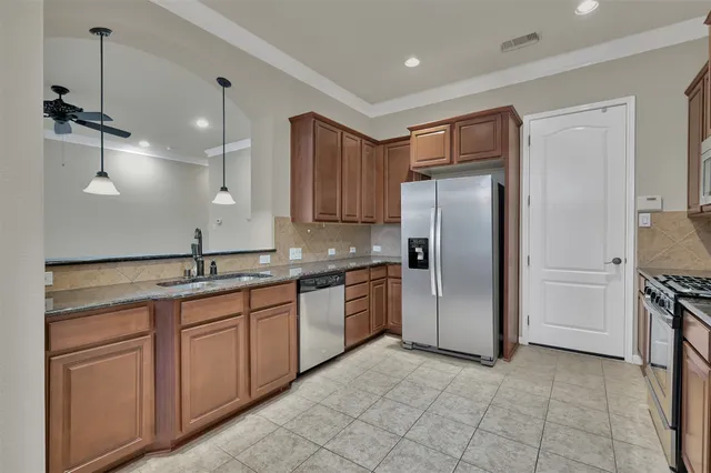 a kitchen with stainless steel appliances granite countertop white cabinets and stove top oven