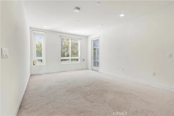a kitchen with white cabinets and refrigerator