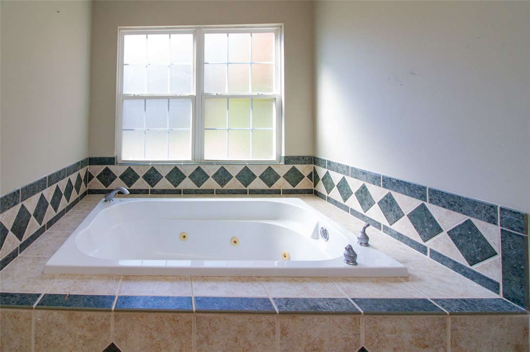 735 Britton Street Anderson, SC 29621 - Photo 27 of 50 Relax in this inviting soaking tub, complete with elegant tile surround and natural light.
