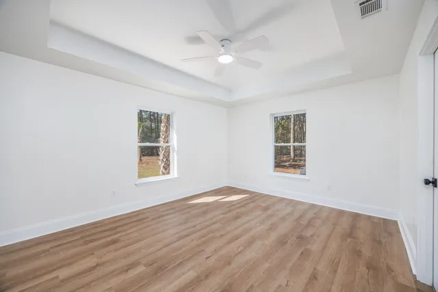 a view of a kitchen with a sink dishwasher a refrigerator and wooden floor