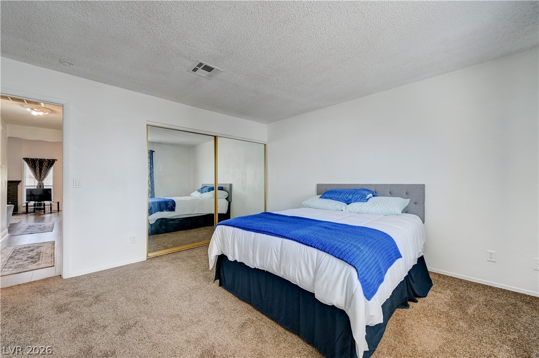 1751 East Reno Avenue, Unit 228 Las Vegas, NV 89119 - Photo 27 of 39 A restful bedroom offers ample storage with mirrored closet doors and soft carpeting.
