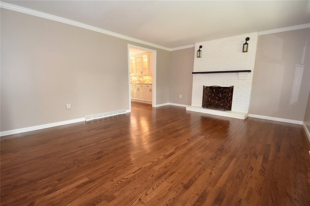 2356 Cramden Road Pittsburgh, PA 15241 - Photo 3 of 25 First floor living room is 17' x 14' with a gas burning fireplace, neutral walls, crown molding and gleaming hard wood flooring! Picture yourself in this spacious room! This room can also be used as a dining room & family room!