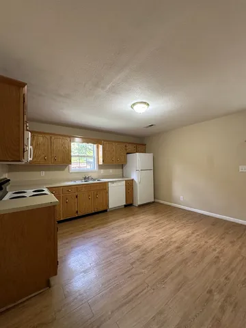 a view of a kitchen with a sink and a dishwasher