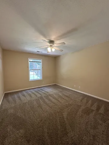 an empty room with a empty space and windows