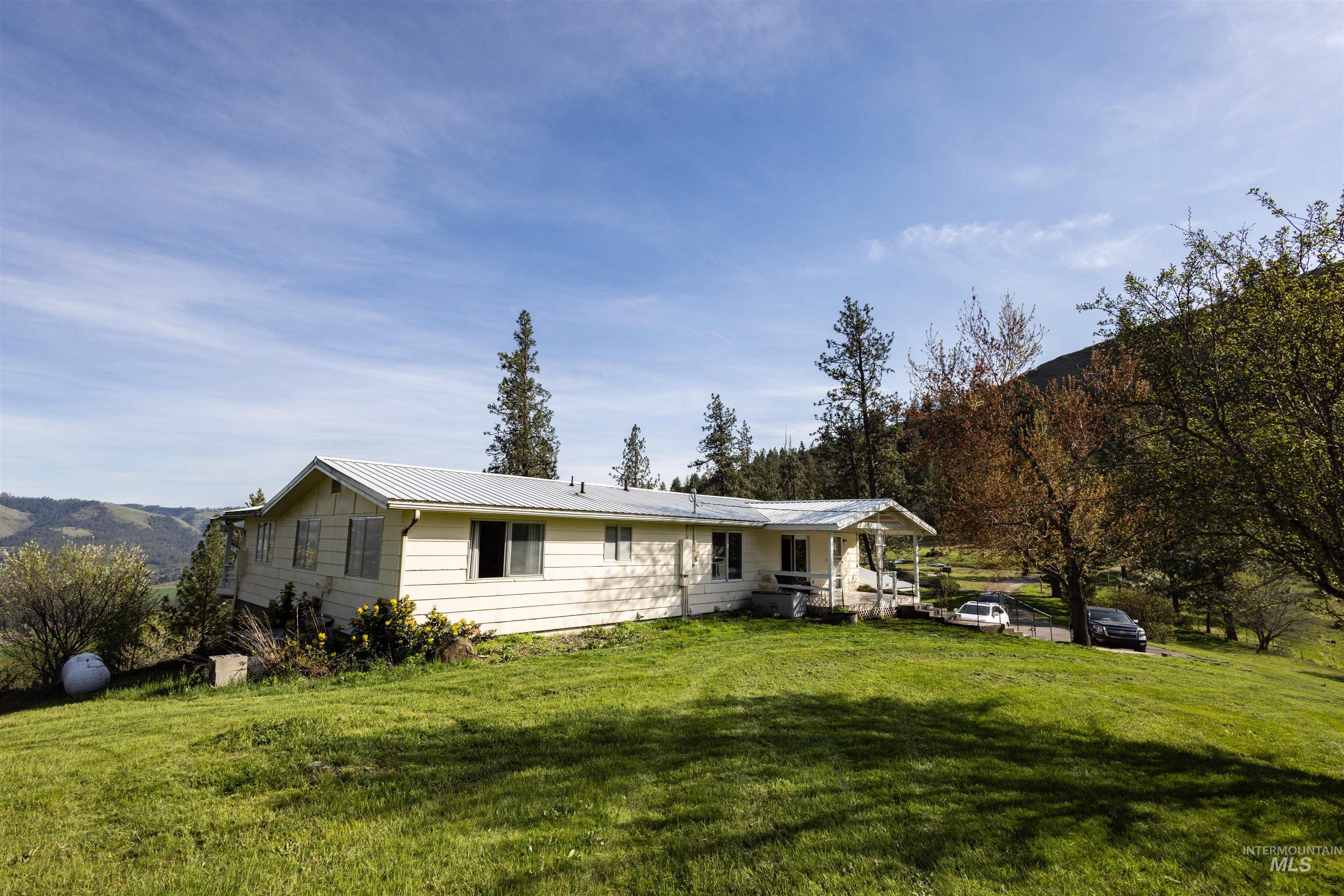 3230 Highway 64 Kamiah, ID 83536 - Photo 19 of 50 View of front of home featuring a metal roof and a front yard