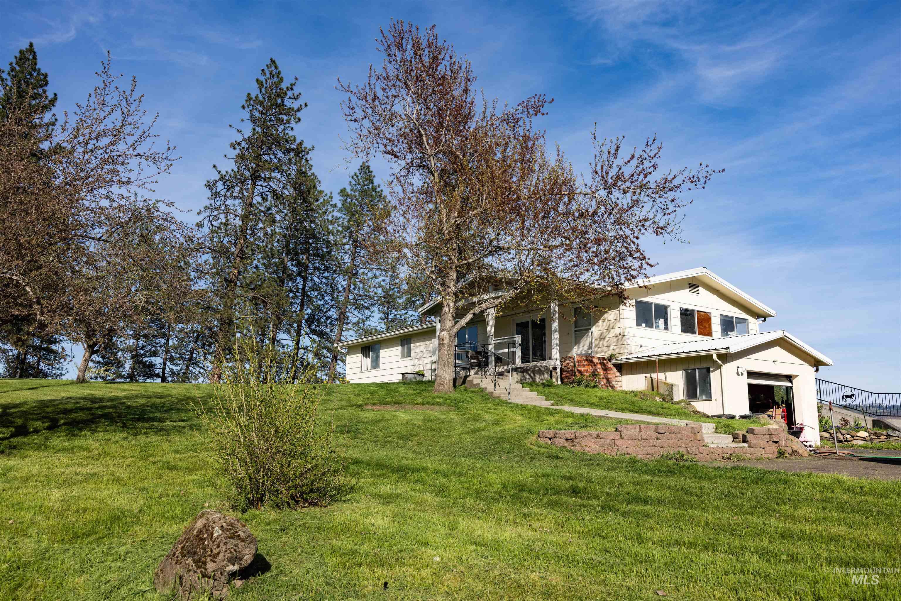 3230 Highway 64 Kamiah, ID 83536 - Photo 25 of 50 View of front of house with a front yard, a patio area, and a metal roof