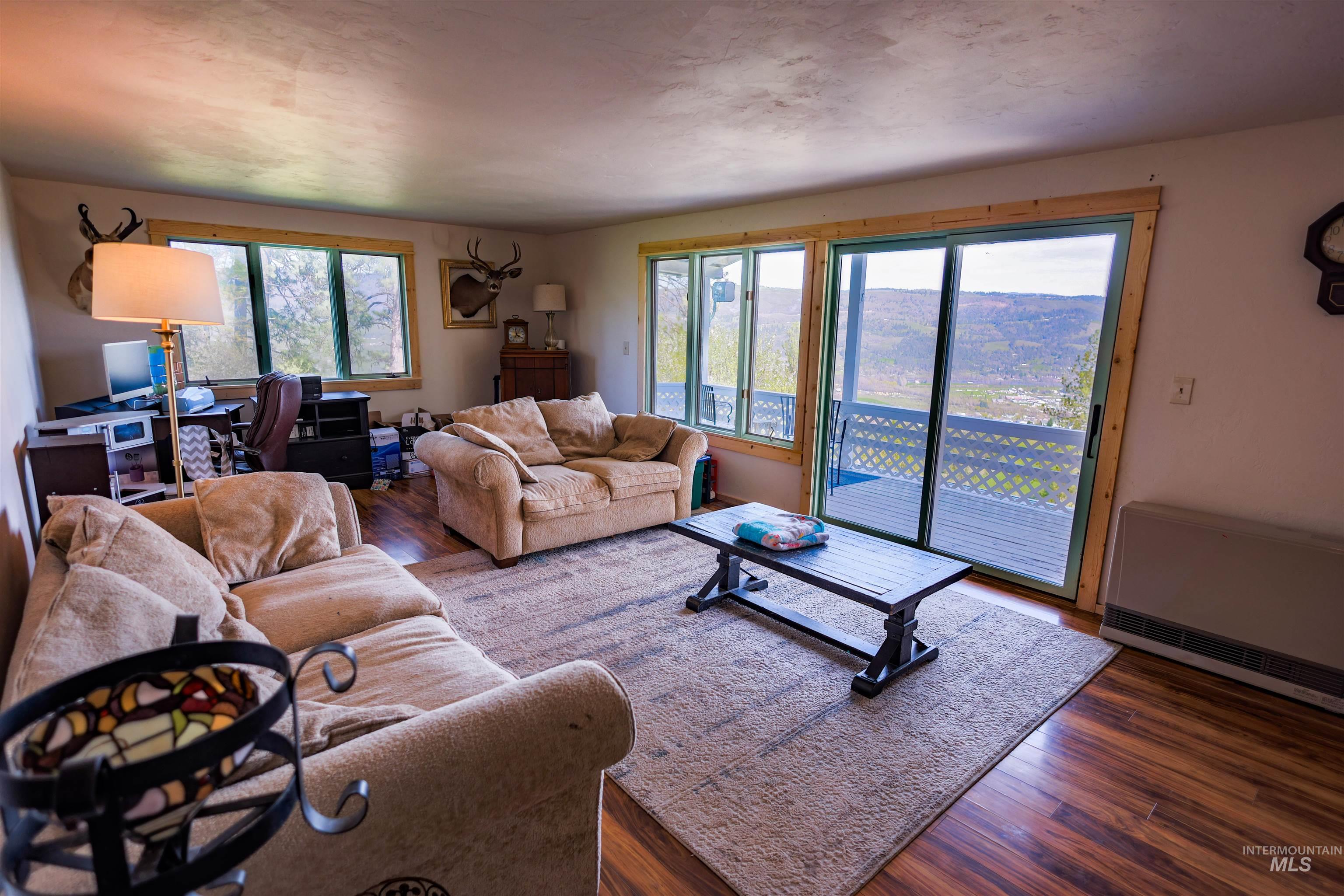 3230 Highway 64 Kamiah, ID 83536 - Photo 36 of 50 Living room featuring dark wood finished floors and heating unit
