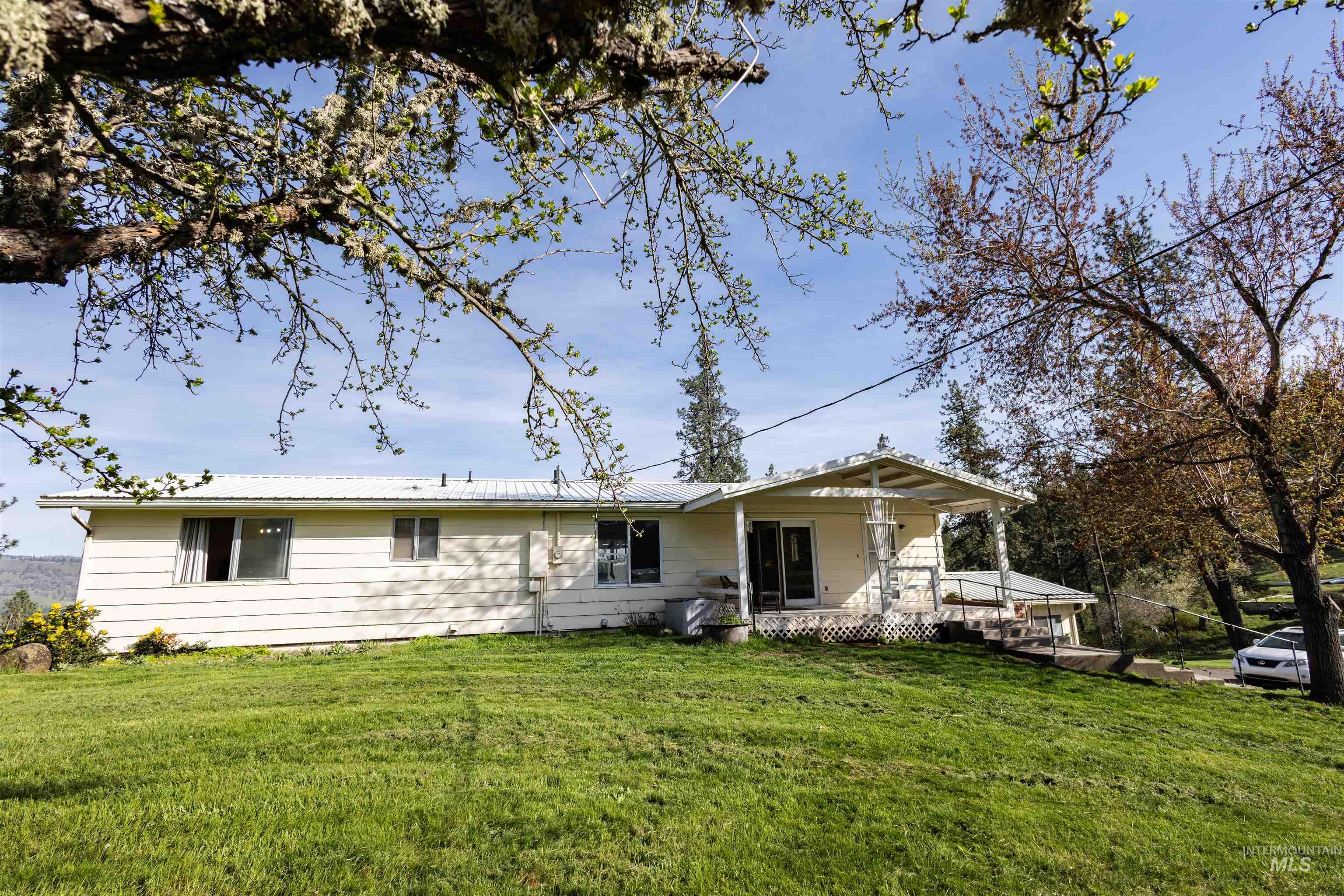 3230 Highway 64 Kamiah, ID 83536 - Photo 4 of 50 Rear view of property featuring a lawn and a metal roof
