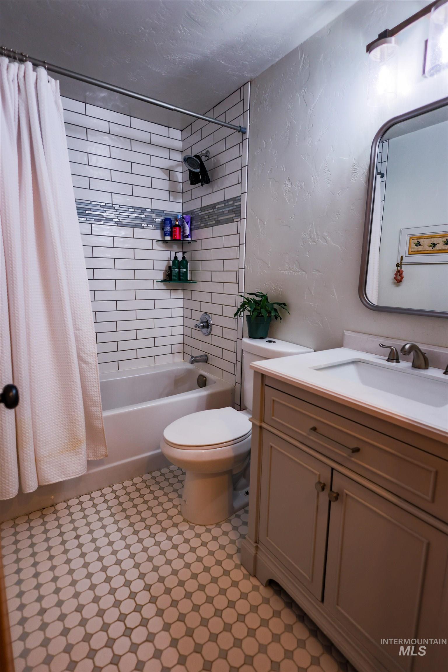 3230 Highway 64 Kamiah, ID 83536 - Photo 41 of 50 Bathroom featuring a textured wall, vanity, and shower / tub combo