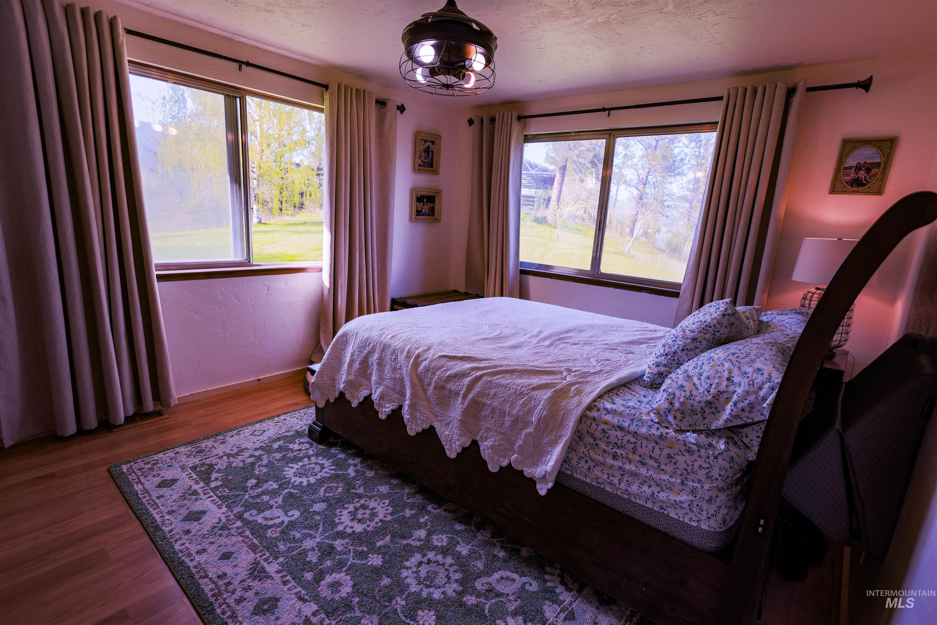 3230 Highway 64 Kamiah, ID 83536 - Photo 42 of 50 Bedroom featuring wood finished floors and multiple windows