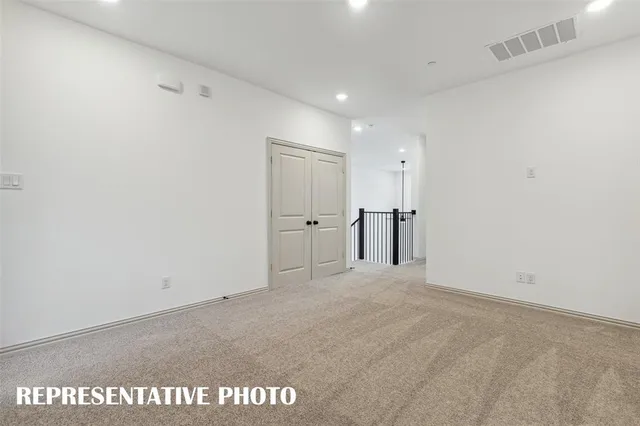 an empty room with windows and ceiling fan