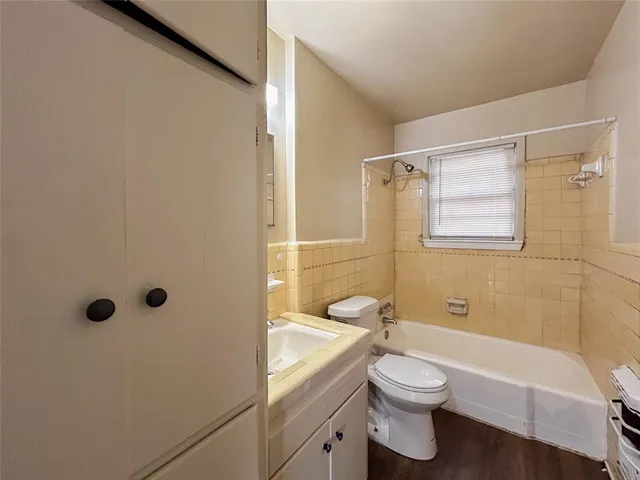 a bathroom with a granite countertop toilet a sink and a bathtub