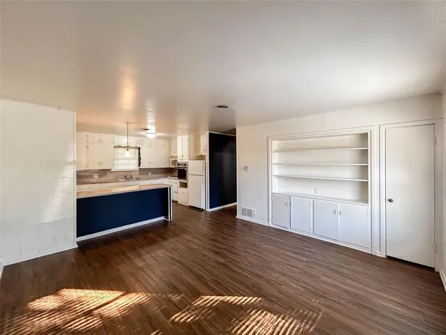 a room with a bed and cabinets