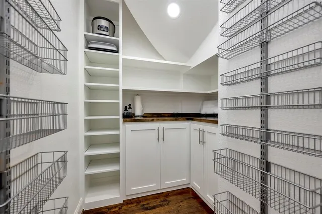 a view of walk in closet with empty racks