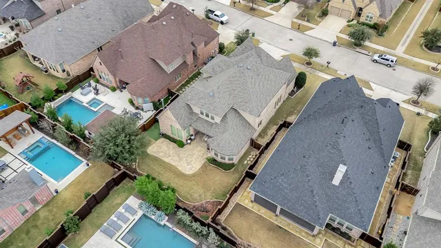 an aerial view of a house with a yard