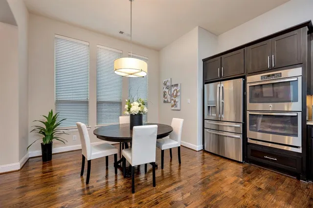 a view of a dining room with furniture window and wooden floor