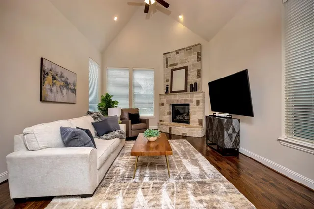 a living room with furniture a flat screen tv and a fireplace